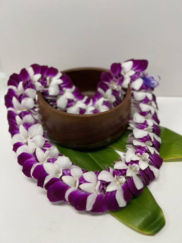 Iris lei made with white and purple orchid blooms